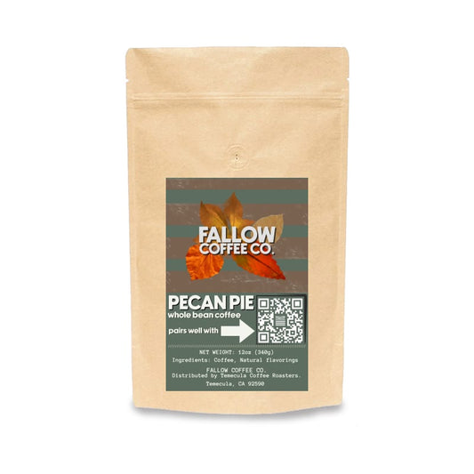 A stand-up kraft paper pouch of Fallow Coffee Co. Pecan Pie whole bean coffee, featuring a dark green label with autumn leaves and a QR code on a white background.